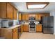 Updated kitchen with stainless steel appliances, wood cabinets, and neutral flooring at 100 Gum Creek Landing, Oxford, GA 30054