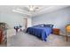 Spacious main bedroom featuring tray ceilings and carpeting, with comfortable sitting area at 100 Gum Creek Landing, Oxford, GA 30054