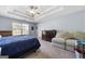 Spacious main bedroom with tray ceiling, neutral tones, carpet flooring, and a walk-in closet at 100 Gum Creek Landing, Oxford, GA 30054
