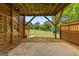 Covered patio area under a deck features a swing and stairs leading to the grassy backyard at 175 Dove Pt, Covington, GA 30016