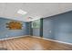 Finished basement with wood-look floors, decorative wall art, and a window with natural light at 175 Dove Pt, Covington, GA 30016