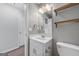 Clean bathroom features a white vanity with sink, a large mirror and updated lighting at 175 Dove Pt, Covington, GA 30016