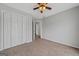 Neutral bedroom with carpeted floors, a ceiling fan, and ample closet space for storage at 175 Dove Pt, Covington, GA 30016