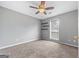 Bedroom with carpet, natural light from a window, floating wood shelves and ceiling fan at 175 Dove Pt, Covington, GA 30016