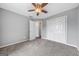 This bedroom has a ceiling fan, carpeted floors, and a spacious closet at 175 Dove Pt, Covington, GA 30016
