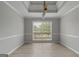 Bright dining room with neutral walls, tile floors and a large window overlooking the backyard at 175 Dove Pt, Covington, GA 30016