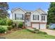 Charming two-story home featuring a brick-accented facade, two-car garage, and a landscaped front yard at 175 Dove Pt, Covington, GA 30016