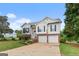 Charming two-story home features a brick-accented facade, two-car garage, landscaped front yard and long driveway at 175 Dove Pt, Covington, GA 30016
