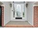 Close-up of the front door that has an ornate glass design, sidelights, and brick trim at 175 Dove Pt, Covington, GA 30016