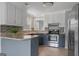 Kitchen featuring granite counters, stainless steel appliances, neutral paint and mosaic backsplash at 175 Dove Pt, Covington, GA 30016