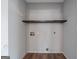 A blank Laundry Room with a dark wooden shelf at 175 Dove Pt, Covington, GA 30016