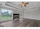 Bright living room featuring a fireplace, hardwood floors, coffered ceiling, and large windows at 175 Dove Pt, Covington, GA 30016