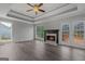 Cozy living room with fireplace, coffered ceiling, hardwood floors, and access to the deck at 175 Dove Pt, Covington, GA 30016