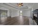 Open living room with fireplace, hardwood floors, coffered ceiling, and abundant natural light at 175 Dove Pt, Covington, GA 30016