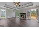 Cozy living room featuring a fireplace, hardwood floors, coffered ceiling, and access to the deck at 175 Dove Pt, Covington, GA 30016