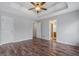 Main bedroom with wood floors, a ceiling fan and a tray ceiling at 175 Dove Pt, Covington, GA 30016