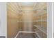 An organized walk-in closet with wall-mounted shelving for storage solutions at 175 Dove Pt, Covington, GA 30016