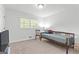 This cozy carpeted bedroom features a simple daybed, ample natural light and neutral walls at 2425 Clifton Springs Rd, Decatur, GA 30034