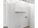 A simple laundry hookup area features white cabinets and hardwood floors at 2425 Clifton Springs Rd, Decatur, GA 30034