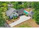 Aerial view showcases the home's inground pool, multiple garages, and lush surrounding greenery at 332 Judy Dr, Mcdonough, GA 30253
