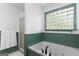 Relaxing bathroom with a large bathtub, glass block window, and updated fixtures at 332 Judy Dr, Mcdonough, GA 30253