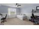 Bedroom featuring carpet floors, a ceiling fan, natural light, and space for an office at 332 Judy Dr, Mcdonough, GA 30253