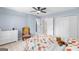 A bright bedroom features a plush quilt, a large window, and a dresser at 332 Judy Dr, Mcdonough, GA 30253