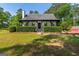 Charming home featuring a covered front porch, manicured landscaping, and a lush green lawn at 332 Judy Dr, Mcdonough, GA 30253