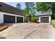 View of the garages connected by a pergola covered in green plants at 332 Judy Dr, Mcdonough, GA 30253