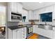 Well-lit kitchen with stainless appliances, white cabinets, black countertops, and subway tile backsplash at 332 Judy Dr, Mcdonough, GA 30253