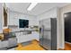 Modern kitchen features stainless steel appliances, white cabinetry, granite countertops, and hardwood floors at 332 Judy Dr, Mcdonough, GA 30253