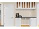 Kitchenette area with white cabinetry, glass display cabinets, and built-in coffee bar with storage at 332 Judy Dr, Mcdonough, GA 30253