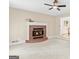 Cozy living room with a brick fireplace and neutral-toned walls, perfect for relaxation at 332 Judy Dr, Mcdonough, GA 30253