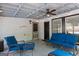 The covered patio has comfortable furniture, a ceiling fan, and good lighting at 332 Judy Dr, Mcdonough, GA 30253
