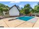 Backyard pool with diving board, surrounded by trees, patio furniture, and greenery at 332 Judy Dr, Mcdonough, GA 30253