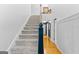 Bright entryway featuring a carpeted staircase and hardwood floors leading to upper level at 332 Judy Dr, Mcdonough, GA 30253