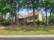 Backyard elevation with a large grass lawn and mature trees at 601 Sawgrass Walk, Mcdonough, GA 30253