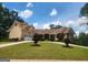 Charming exterior elevation with a well-maintained lawn and attached garage at 601 Sawgrass Walk, Mcdonough, GA 30253