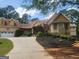 Exterior elevation with a well-maintained lawn, long driveway, and attached garage at 601 Sawgrass Walk, Mcdonough, GA 30253