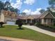 Charming exterior elevation with a well-maintained lawn and attached garage at 601 Sawgrass Walk, Mcdonough, GA 30253