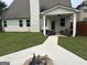 Beautiful home backyard featuring a fire pit, covered patio, and well-manicured lawn at 3970 Lagrone St, Powder Springs, GA 30127