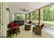 Covered back porch with fire pit, comfy seating, and a hot tub at 218 Woodruff Way, Peachtree City, GA 30269