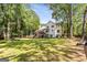 Sprawling backyard surrounded by mature trees, offering ample space and a sense of privacy and seclusion at 218 Woodruff Way, Peachtree City, GA 30269
