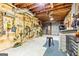 Unfinished basement with wood and cinder block walls and utility shelving at 218 Woodruff Way, Peachtree City, GA 30269