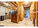 Unfinished basement with concrete floor, wood framing and stored furniture at 218 Woodruff Way, Peachtree City, GA 30269