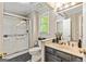 Bathroom features a glass-enclosed shower, vanity, and natural light from the window at 218 Woodruff Way, Peachtree City, GA 30269