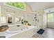Spacious bathroom showcasing a soaking tub, glass shower, and dual sink vanity at 218 Woodruff Way, Peachtree City, GA 30269