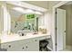 Well-lit bathroom with white cabinets, vanity, and stool, plus a large mirror reflecting the bathtub at 218 Woodruff Way, Peachtree City, GA 30269
