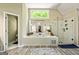 Bright bathroom features a soaking tub, glass shower, and large window bringing in natural light at 218 Woodruff Way, Peachtree City, GA 30269