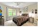 Comfortable bedroom offering natural light, neutral walls, and a decorative plaid bedspread at 218 Woodruff Way, Peachtree City, GA 30269